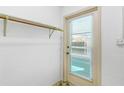 Well-lit mud room with a door to the exterior with a wooden shelf on a white cinder block wall at 450 Liberty Ave # 3, Mount Dora, FL 32757