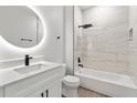 Bathroom with an oversized shower head, round backlit mirror and modern fixtures at 7267 Sw 128Th Terrace Rd, Dunnellon, FL 34432