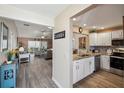 Open-concept kitchen featuring granite countertops and stainless steel appliances at 750 Evelynton Loop, The Villages, FL 32162