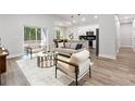 Open living room featuring neutral decor, hardwood floors, sliding glass doors and modern furnishings at 7505 Sw 137Th Court Rd, Dunnellon, FL 34432