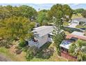 Aerial view of home with a cozy back patio and lush landscaping overlooking the serene surroundings at 756 Heathrow Ave, The Villages, FL 32159