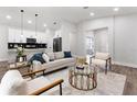 Spacious open-concept living area with modern décor and seamless flow to the kitchen at 8311 Sw 136Th Ter, Dunnellon, FL 34432