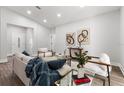 Cozy living area featuring neutral décor, stylish furnishings, and a view to the kitchen at 8311 Sw 136Th Ter, Dunnellon, FL 34432
