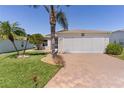 Beautiful home with an attached two-car garage, lush landscaping, and an inviting front yard at 841 Eagles Lndg, Leesburg, FL 34748