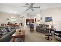 Spacious living room seamlessly connecting to the dining area and kitchen at 859 Parksville Path, The Villages, FL 32162