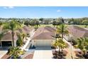 Aerial view of a home showcasing its roof, landscaping, and location on a golf course at 8850 Se 167Th Mayfield Pl, The Villages, FL 32162