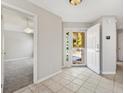 Bright entryway featuring tile flooring, a view of the front yard, and access to other rooms at 8850 Se 167Th Mayfield Pl, The Villages, FL 32162