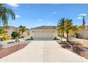 Exterior of home with a wide driveway, well-kept landscaping, and neutral color scheme at 8850 Se 167Th Mayfield Pl, The Villages, FL 32162