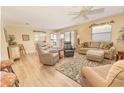 Cozy living room with plush seating, decorative rug, and ample natural light creating a warm and inviting atmosphere at 992 Ridgeville Rd, The Villages, FL 32162