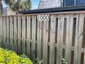 Close-up of the home's address, 1000, displayed on a weathered wooden fence at 1000 Royal Oak Blvd, Leesburg, FL 34748