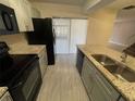 Modern kitchen featuring granite countertops, stainless steel appliances, and gray cabinetry at 1000 Royal Oak Blvd, Leesburg, FL 34748