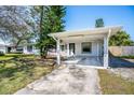 Inviting single-story home with carport, freshly painted siding, and neat front yard at 102 S Sunland Dr, Sanford, FL 32773