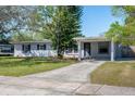 Charming single-story home featuring a covered carport and well-kept front lawn at 102 S Sunland Dr, Sanford, FL 32773