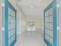 Bright entryway with blue doors and porcelain tile floors at 11743 Se 174Th Loop, Summerfield, FL 34491