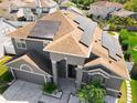 Striking overhead view of the two-story home featuring solar panels and a well-maintained yard at 13519 Bristlecone Cir, Orlando, FL 32828