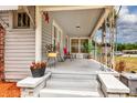 Spacious front porch with ample seating and decorative plants, perfect for relaxing outdoors at 1515 Washington Ave, Eustis, FL 32726