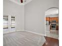 Bright living room with wood and carpet floors leading to kitchen with stainless steel appliances at 15803 Fairview Pt, Tavares, FL 32778