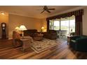 Cozy living room with hardwood floors, comfortable seating, and sliding doors to patio at 1721 Carrera Dr, The Villages, FL 32159