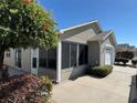 Exterior of the house featuring a cozy screened in patio at 2523 Mariel Way, The Villages, FL 32162