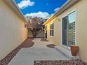 A narrow courtyard featuring a quaint garden design and stone-lined walkway at 880 Radclife Berea Pl, The Villages, FL 32162