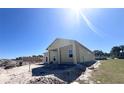 Newly constructed single-story home with a covered porch and a spacious yard, ready for personalization at 981 Fiesta Key Cir, Lady Lake, FL 32159