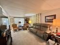 Cozy living room with ample seating and natural light at 101 Royal Palm Dr, Leesburg, FL 34748