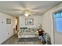 Bright living room featuring a ceiling fan and hard surface flooring at 101 Royal Palm Dr, Leesburg, FL 34748