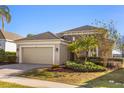 Charming single-story home with manicured lawn, beautiful stone details, and a convenient two-car garage at 1023 Timbervale Trl, Clermont, FL 34715