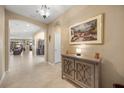 Inviting hallway with tile flooring, arched doorways, and a decorative console table at 1023 Timbervale Trl, Clermont, FL 34715