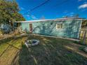 Side view of the house with small stone firepit at 103 Caroline Ave, Lady Lake, FL 32159