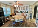 Cozy dining area features a round table, built-in cabinets, and a ceiling fan at 111 Azalea Trl, Leesburg, FL 34748