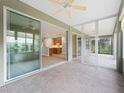 Screened lanai featuring tile flooring and views of the kitchen and living area through sliding glass doors at 11759 Se 91St Cir, Summerfield, FL 34491