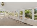 Bright sunroom filled with natural light, featuring carpet flooring and views of the outdoors at 17108 Pine Ridge Dr, Umatilla, FL 32784