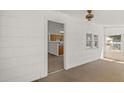 View from sunroom of kitchen, with carpet flooring and bright white walls at 17108 Pine Ridge Dr, Umatilla, FL 32784