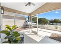 Relaxing screened patio with ceiling fan and view of the lovely yard and picket fence at 1773 Hallandale Ln, The Villages, FL 32162