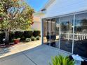 A sunroom features large windows, neutral patio furniture, and serene views at 2569 Errol Ter, The Villages, FL 32162