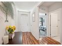Inviting entryway with wood flooring, a stylish console table, and a glimpse into the bedroom at 2916 Canary Ln, Tavares, FL 32778