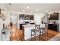 Spacious kitchen features stainless steel appliances, a center island with breakfast bar, and stylish cabinetry at 2916 Canary Ln, Tavares, FL 32778