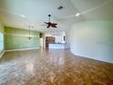 Spacious living room with tile floors, high ceilings, large windows, and open to the kitchen at 30454 Island Club Dr, Deer Island, FL 32778