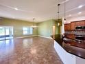 Bright, open-concept living room and kitchen featuring tile floors and plenty of natural light at 30454 Island Club Dr, Deer Island, FL 32778