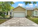 Home featuring a spacious two-car garage and landscaped front yard at 6152 Topsail Rd, Lady Lake, FL 32159
