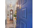 Inviting entryway features wood-look flooring, a charming grandfather clock, and a striking blue front door at 628 Mount Homer Rd # 4B, Eustis, FL 32726
