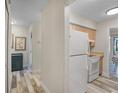 Efficient kitchenette with white appliances, wood cabinets, and attractive flooring at 628 Mount Homer Rd # 4B, Eustis, FL 32726