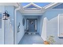 Front porch and door adorned with a wreath and neutral welcome mat at 6444 Mcknight Loop, The Villages, FL 34762