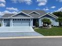 Charming single-story home with a well-manicured lawn and tasteful landscaping at 6444 Mcknight Loop, The Villages, FL 34762