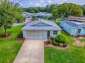 An aerial shot of a charming single-Gathering home surrounded by verdant lawns at 701 Cottage Park Ln, Leesburg, FL 34748