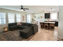 Open-concept living room with a sectional couch, lots of natural light and dining area at 916 Carmillion Ct, Groveland, FL 34736