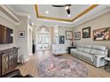 Spacious living room featuring a decorative ceiling, neutral color scheme, and lots of wall decor at 10199 Mainsail Dr, Oxford, FL 34484