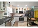 Stylish kitchen with modern appliances, white cabinetry, and a stainless steel farmhouse sink at 110 N Tremain St # 205, Mount Dora, FL 32757