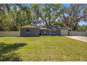 Inviting single-story home featuring a well-maintained lawn and attached garage at 1107 Valley Rd, Fruitland Park, FL 34731